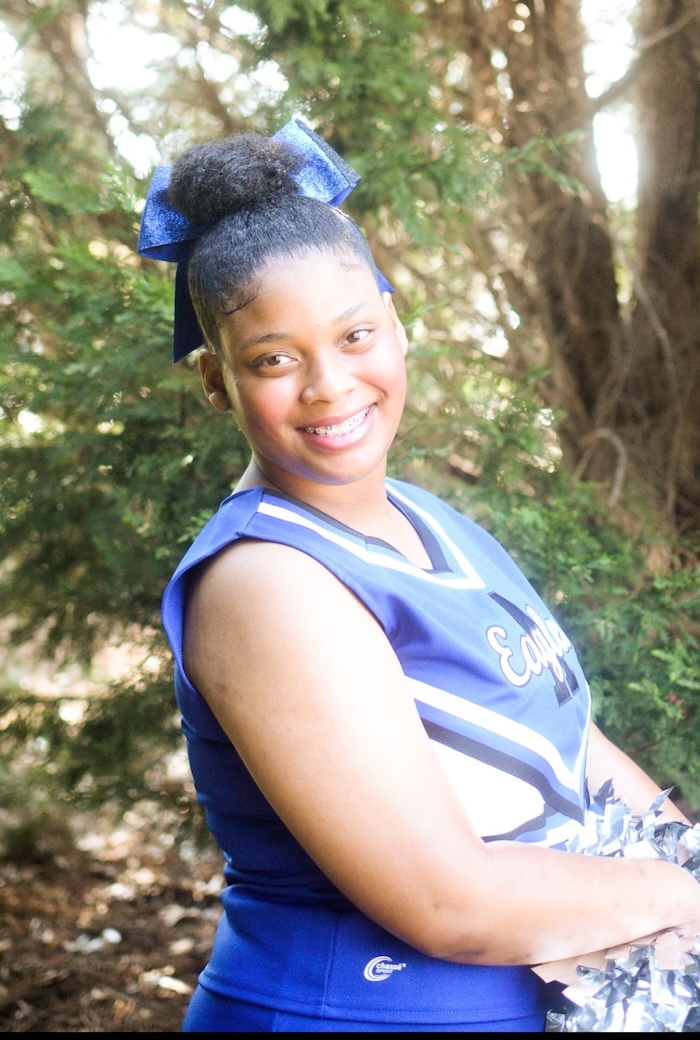 Zoe-Rebekah Bostic is a cheerleading uniform